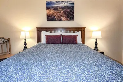 a bedroom with a blue bed with two lamps at Griffons Nest in Silverthorne