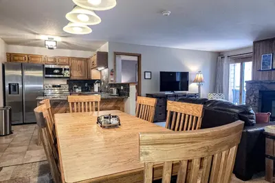 a kitchen and living room with a table and a couch at Griffons Nest in Silverthorne