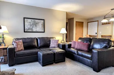 a living room with a couch and two chairs at Griffons Nest in Silverthorne