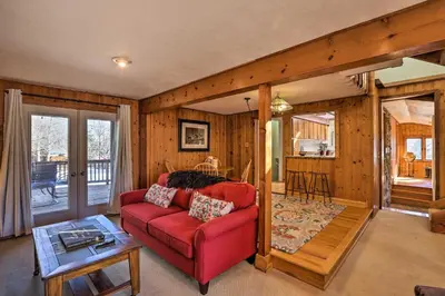 a living room with a red couch and a table at 5 Mi to Dtwn Denver Peaceful Lakewood Home! in Lakewood