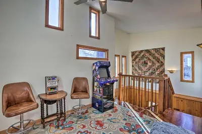 a living room with two chairs and a glass table at 5 Mi to Dtwn Denver Peaceful Lakewood Home! in Lakewood