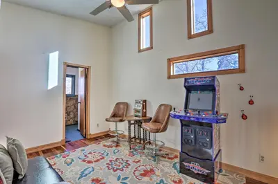 a living room with a video game console and chairs at 5 Mi to Dtwn Denver Peaceful Lakewood Home! in Lakewood