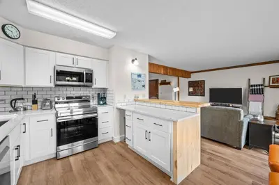 a kitchen with white cabinets and a stove top oven at 265 Forest Trail in Winter Park