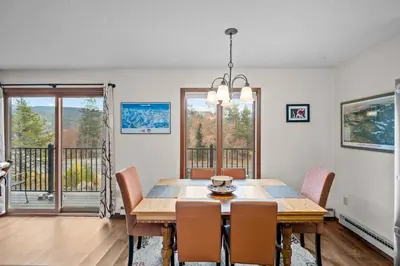 a dining room with a wooden table and chairs at 265 Forest Trail in Winter Park