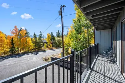 a balcony of a house with a road and trees at 265 Forest Trail in Winter Park