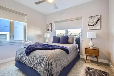 a bedroom with a large bed and a window at 2332 N Clay Street Unit #3 in Denver