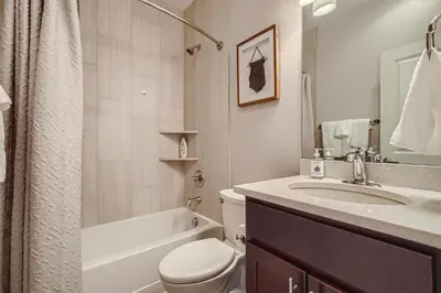 a bathroom with a sink and a toilet and a bath tub at 2332 N Clay Street Unit #3 in Denver