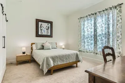 a bedroom with a bed and a table and a window at 5419 Allison St, Unit G in Arvada