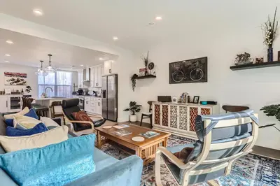 a living room with blue chairs and a table at 5419 Allison St, Unit G in Arvada
