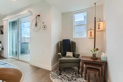 a living room with a chair and a table at 5419 Allison St, Unit G in Arvada