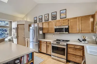 a kitchen with wooden cabinets and stainless steel appliances at 6022 Yank Ct in Arvada