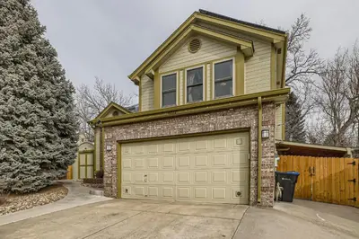 a house with a garage door in a driveway at 6022 Yank Ct in Arvada