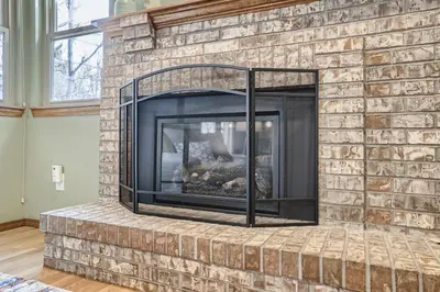 a brick fireplace with a fire place at 6022 Yank Ct in Arvada