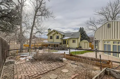a home with a fence and a house at 6022 Yank Ct in Arvada