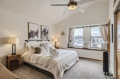 a bedroom with a bed and a ceiling fan at 6022 Yank Ct in Arvada