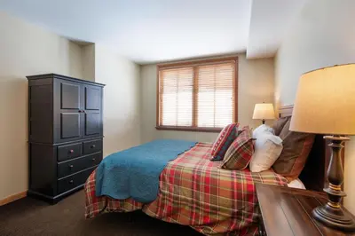 a bedroom with a bed and a dresser and a window at Zephyr Mountain Lodge, Condo - 3 Bedroom Select-Rated Condo 1609 condo in Winter Park