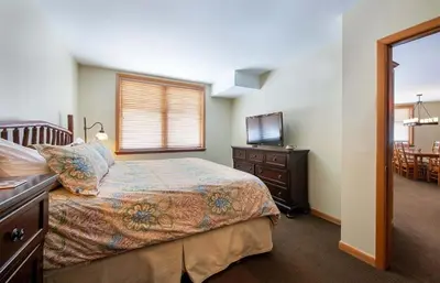 a bedroom with a bed and a dresser and a window at Zephyr Mountain Lodge, Condo - 3 Bedroom Select-Rated Condo 1609 condo in Winter Park
