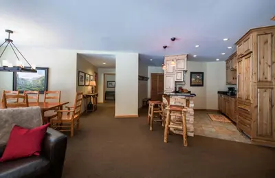 a living room and kitchen with a couch and a table at Zephyr Mountain Lodge, Condo - 3 Bedroom Select-Rated Condo 1609 condo in Winter Park
