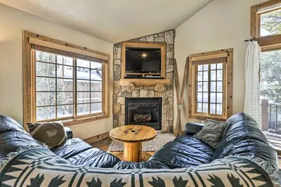 a living room with a couch and a fireplace at Mountainside Winter Park Ski Home with Hot Tub in Winter Park