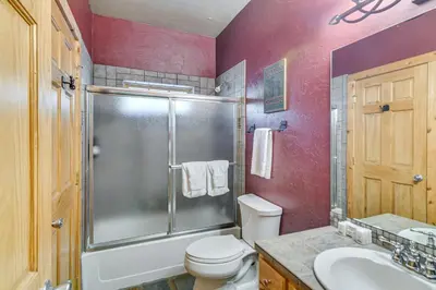 a bathroom with a shower and a toilet and a sink at Mountainside Winter Park Ski Home with Hot Tub in Winter Park