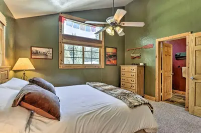 a bedroom with a bed and a ceiling fan at Mountainside Winter Park Ski Home with Hot Tub in Winter Park