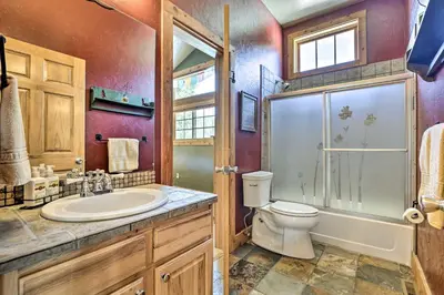 a bathroom with a toilet and a shower and a sink at Mountainside Winter Park Ski Home with Hot Tub in Winter Park