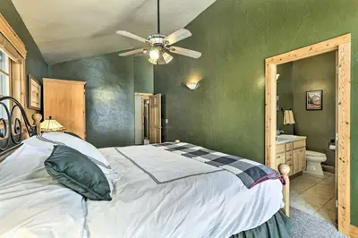 a bedroom with a bed and a ceiling fan at Mountainside Winter Park Ski Home with Hot Tub in Winter Park