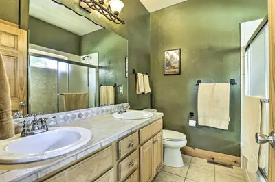 a bathroom with two sinks and a toilet at Mountainside Winter Park Ski Home with Hot Tub in Winter Park