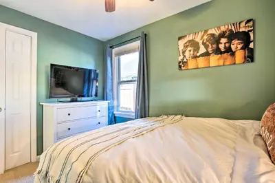 a bedroom with a bed and a flat screen tv at Less Than 1 Mi to Empower Field Denver Vacation Rental in Denver