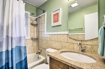 a bathroom with a sink and a tub and a toilet at Less Than 1 Mi to Empower Field Denver Vacation Rental in Denver