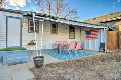 a patio with a table and chairs in front of a house at Less Than 1 Mi to Empower Field Denver Vacation Rental in Denver