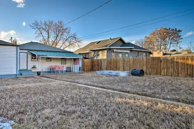a yard with a fence and a house at Less Than 1 Mi to Empower Field Denver Vacation Rental in Denver