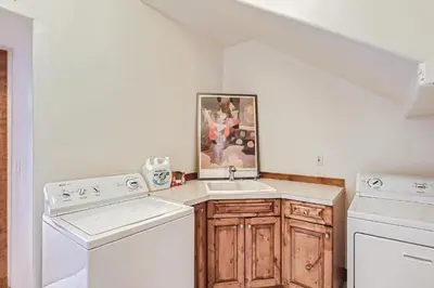 a white laundry room with a sink and washing machines at NEW LISTING! Après & Fairway Retreat home in Breckenridge
