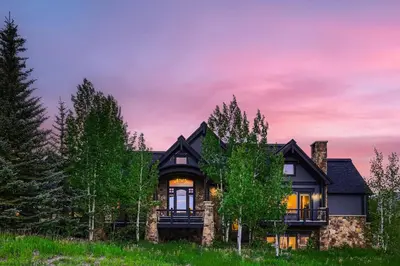 a house with a sunset in the background at NEW LISTING! Après & Fairway Retreat home in Breckenridge