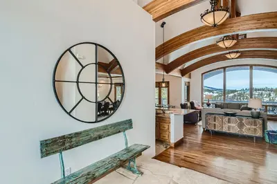 a living room with a large mirror on the wall at NEW LISTING! Après & Fairway Retreat home in Breckenridge