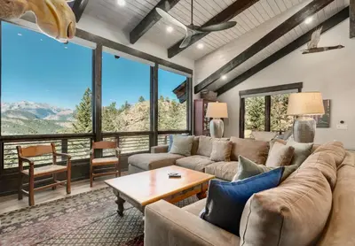 a living room with couches and a table at Moose Den Luxury Vacation Home at Windcliff home in Estes Park