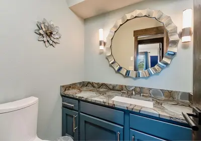 a bathroom with a sink and a mirror at Moose Den Luxury Vacation Home at Windcliff home in Estes Park