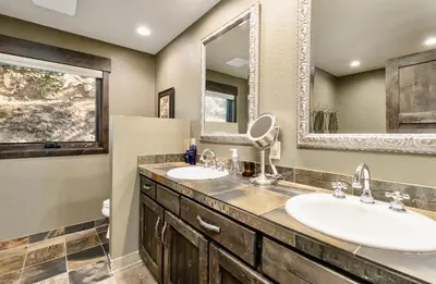 a bathroom with two sinks and a mirror at Moose Den Luxury Vacation Home at Windcliff home in Estes Park