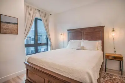 a bedroom with a large bed and a window at Cozy- Mountain Style - River View apartment - Colorado in Silverthorne