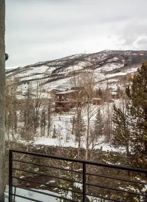 a view of a snow covered hill with a house at Cozy- Mountain Style - River View apartment - Colorado in Silverthorne
