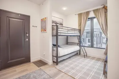 a bedroom with a bunk bed and a window at Cozy- Mountain Style - River View apartment - Colorado in Silverthorne