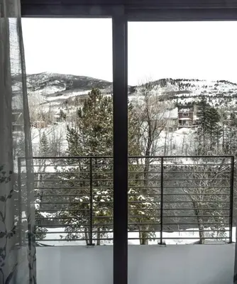 a window with a view of a snow covered mountain at Cozy- Mountain Style - River View apartment - Colorado in Silverthorne