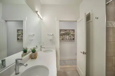 a white bathroom with two sinks and a shower at Cozy- Mountain Style - River View apartment - Colorado in Silverthorne