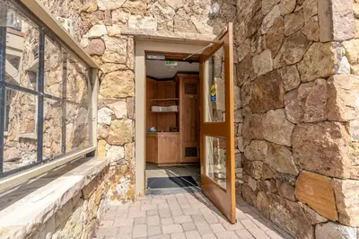 an open door into a stone building with a stone wall at Lone Eagle 3017 in Keystone
