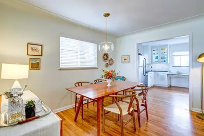 a dining room and living room with a table and chairs at Near Denver Zoo Home with Furnished Patio! in Denver