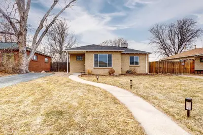 a house with a driveway in front of a yard at Near Denver Zoo Home with Furnished Patio! in Denver