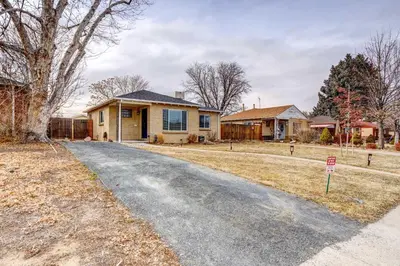 a house with a driveway in front of a house at Near Denver Zoo Home with Furnished Patio! in Denver