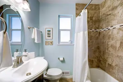 a bathroom with a tub and a sink and a toilet at Near Denver Zoo Home with Furnished Patio! in Denver