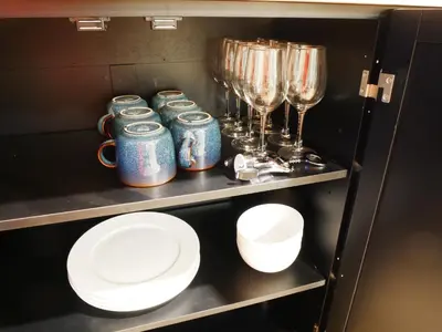 a kitchen with white plates and wine glasses at Private Basement, Bath, Living Area In Morrison in Morrison