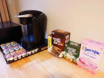 a coffee maker and a box of donuts on the floor at Private Basement, Bath, Living Area In Morrison in Morrison
